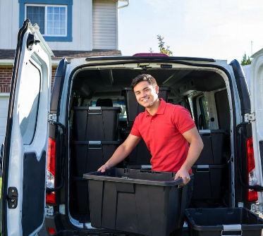 ToteRental team member unloading totes from a white delivery van at a customer's home